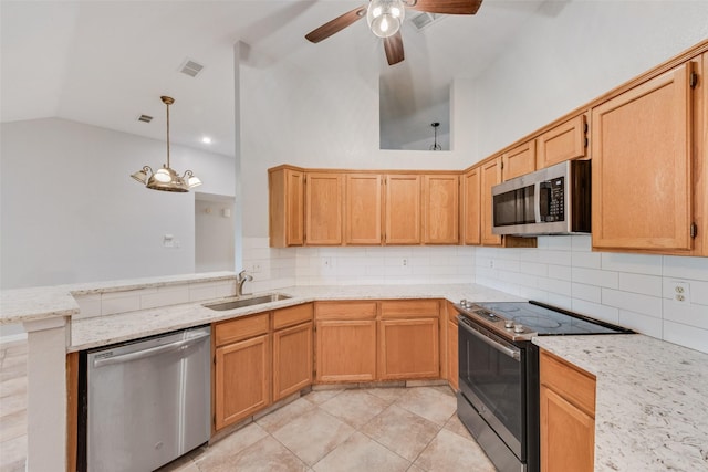 kitchen featuring visible vents, a ceiling fan, a sink, vaulted ceiling, and stainless steel appliances