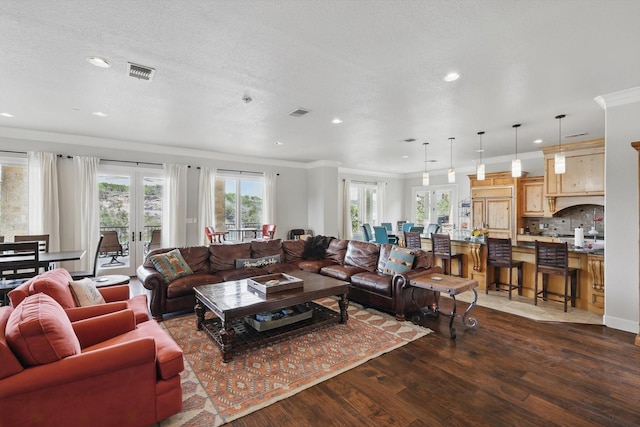 living room with visible vents, ornamental molding, dark wood finished floors, and recessed lighting