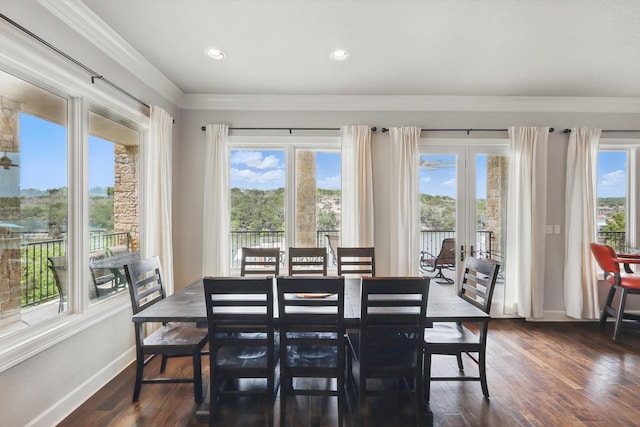 dining room featuring crown molding, baseboards, and a healthy amount of sunlight