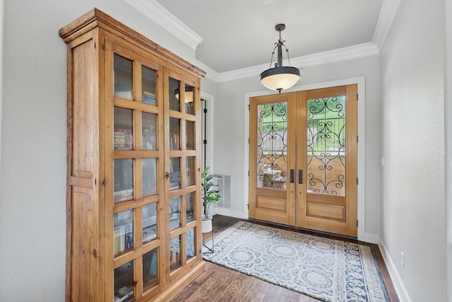 foyer featuring baseboards, ornamental molding, french doors, and wood finished floors