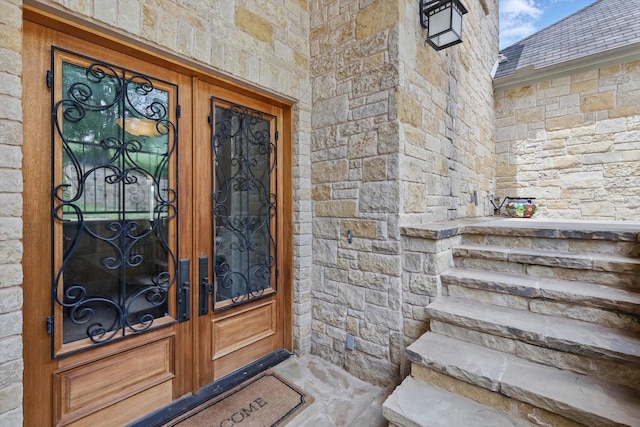 doorway to property with french doors and stone siding