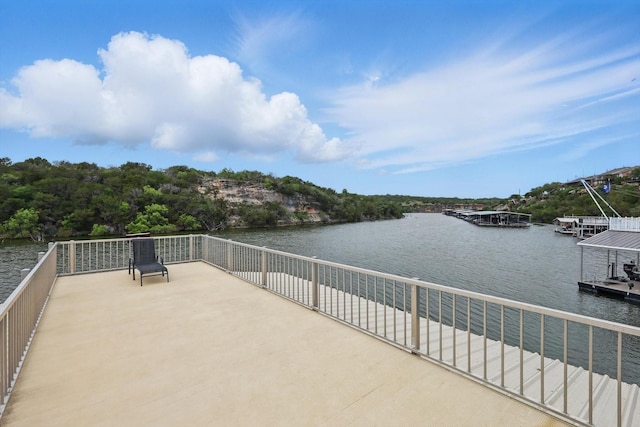 view of patio with a floating dock and a water view