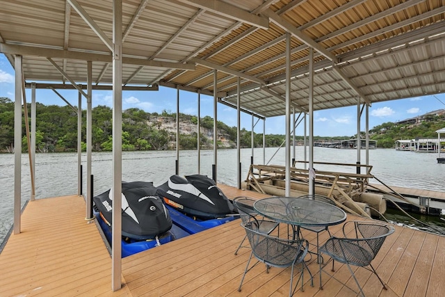 view of dock with boat lift and a water view