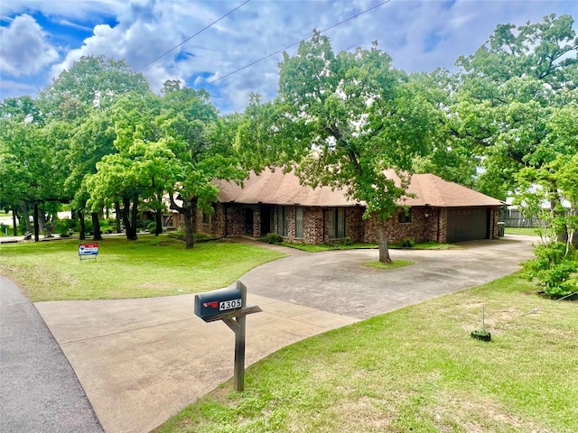 view of front of house with an attached garage, driveway, and a front yard