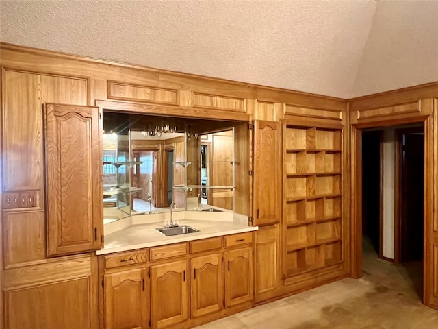 bar featuring a sink, a textured ceiling, vaulted ceiling, and wood walls