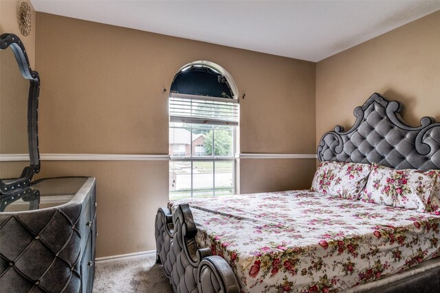 bedroom with baseboards and carpet