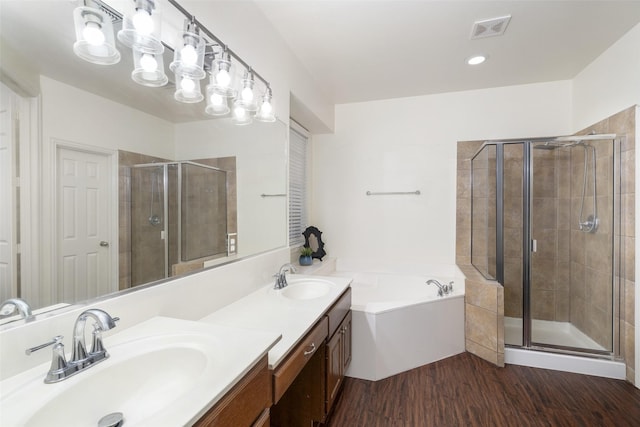 3136 Deer Run Dr, Little Elm, TX 75068 - bathroom featuring a stall shower, a bath, double vanity, and wood finished floors