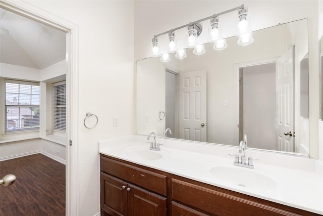 3136 Deer Run Dr, Little Elm, TX 75068 - bathroom featuring double vanity, baseboards, wood finished floors, and vaulted ceiling