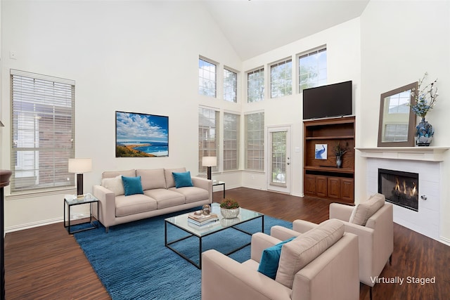 3136 Deer Run Dr, Little Elm, TX 75068 - living room featuring high vaulted ceiling, wood finished floors, a fireplace, baseboards, and plenty of natural light