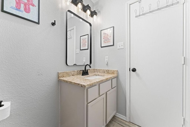300 Aspenwood Trl, Forney, TX 75126 - bathroom with vanity, a textured wall, and wood finished floors