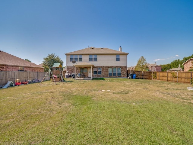300 Aspenwood Trl, Forney, TX 75126 - rear view of property featuring brick siding, a fenced backyard, a chimney, a playground, and a lawn