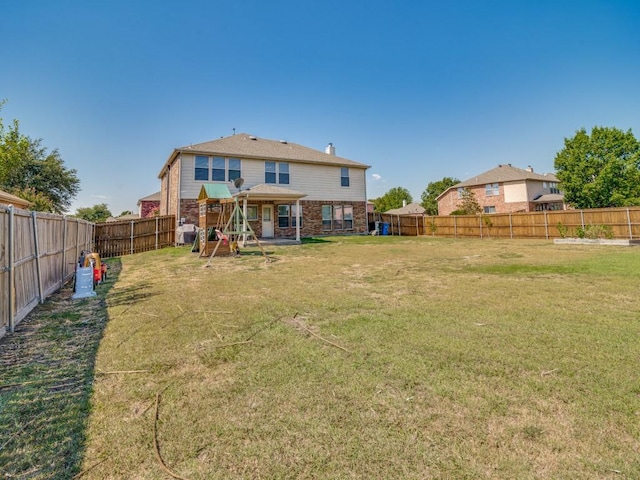 300 Aspenwood Trl, Forney, TX 75126 - back of property with a fenced backyard, a lawn, and brick siding