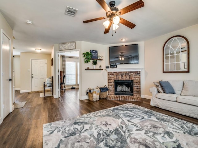 300 Aspenwood Trl, Forney, TX 75126 - living room featuring ceiling fan, a brick fireplace, baseboards, dark wood-type flooring, and visible vents