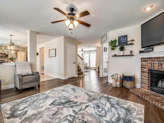300 Aspenwood Trl, Forney, TX 75126 - living room featuring a brick fireplace, wood finished floors, baseboards, ceiling fan, and stairway