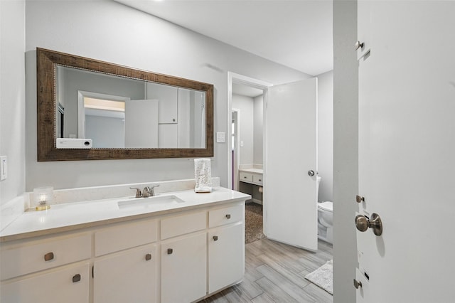 2108 Stonegate Dr N, Bedford, TX 76021 - bathroom featuring vanity, toilet, and wood finished floors