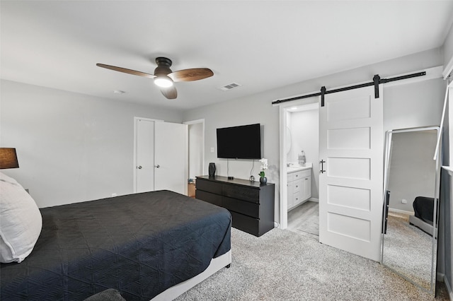 2108 Stonegate Dr N, Bedford, TX 76021 - bedroom with ceiling fan, visible vents, a barn door, ensuite bathroom, and carpet