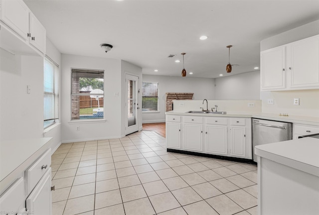 kitchen with dishwasher, a sink, light countertops, a peninsula, and white cabinetry