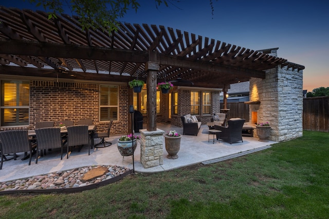 patio terrace at dusk with a lawn, an outdoor living space, fence, and a pergola