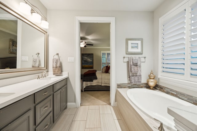 full bath with double vanity, ceiling fan, a bath, a sink, and ensuite bathroom