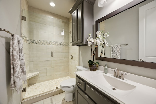 bathroom featuring toilet, recessed lighting, a shower stall, and vanity