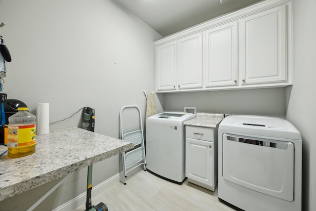 laundry area with cabinet space, baseboards, and washing machine and dryer