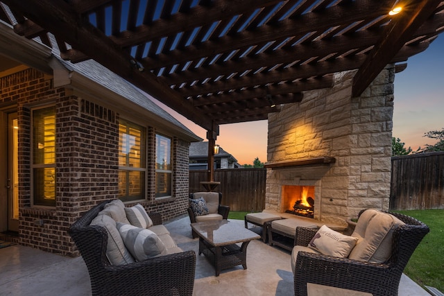 view of patio / terrace featuring a fenced backyard, an outdoor living space with a fireplace, and a pergola