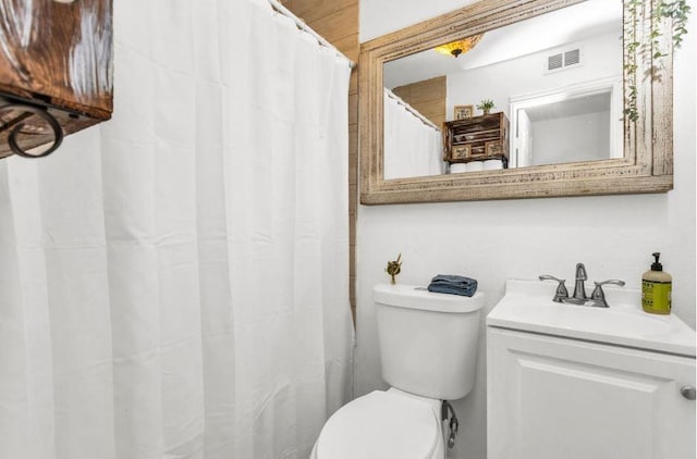 full bath featuring visible vents, toilet, and vanity