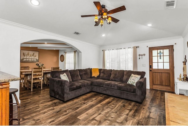 kitchen with black fridge with ice dispenser, brown cabinetry, crown molding, stainless steel gas range, and arched walkways