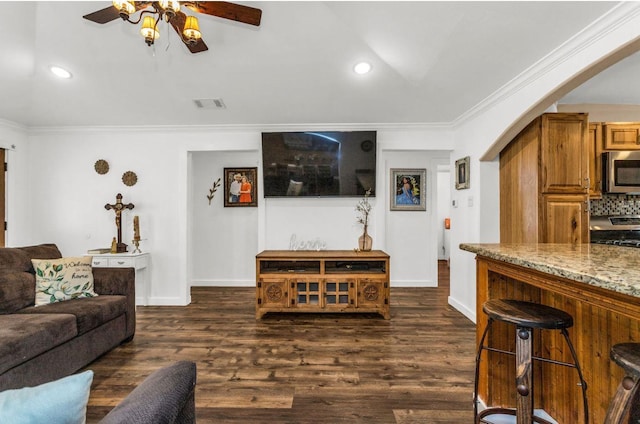 bedroom featuring ornamental molding, a barn door, and wood finished floors