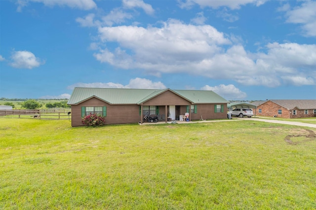 view of front of property with fence, a front yard, and a carport