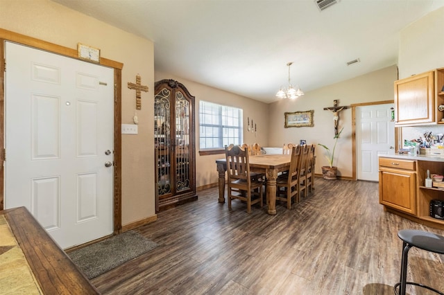 dining space featuring baseboards, vaulted ceiling, dark wood-style floors, and a notable chandelier