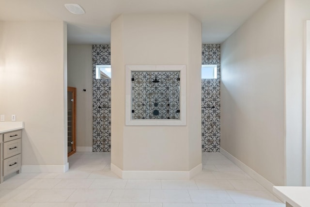 8408 Fullerton Dr, Cleburne, TX 76033 - bathroom featuring a healthy amount of sunlight, vanity, tile patterned flooring, and tiled shower