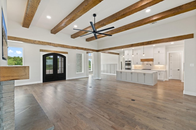 8408 Fullerton Dr, Cleburne, TX 76033 - unfurnished living room featuring french doors, recessed lighting, beamed ceiling, and ceiling fan