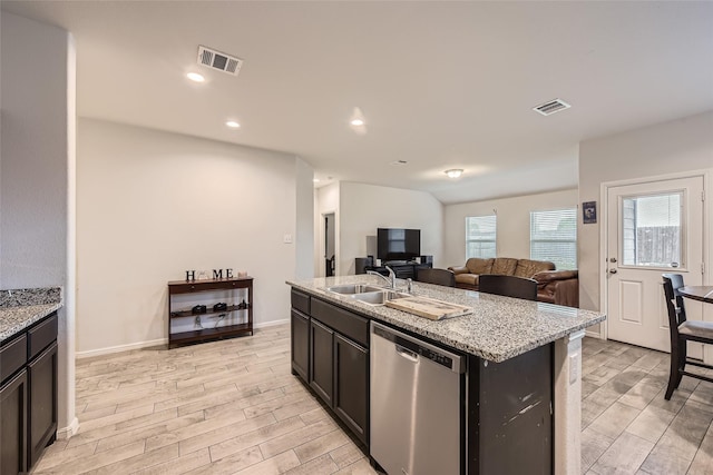 kitchen with visible vents, a sink, light wood finished floors, and dishwasher
