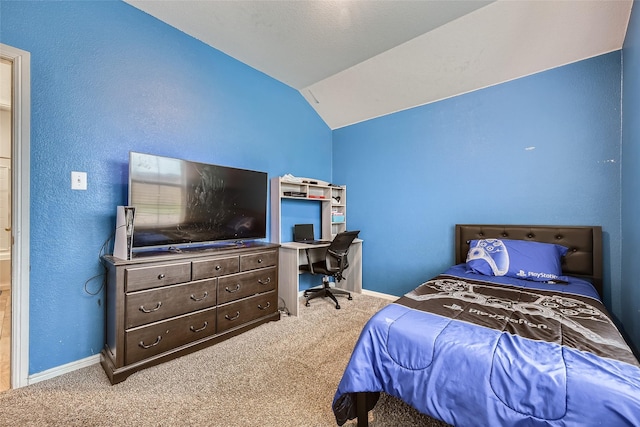 carpeted bedroom featuring baseboards and vaulted ceiling