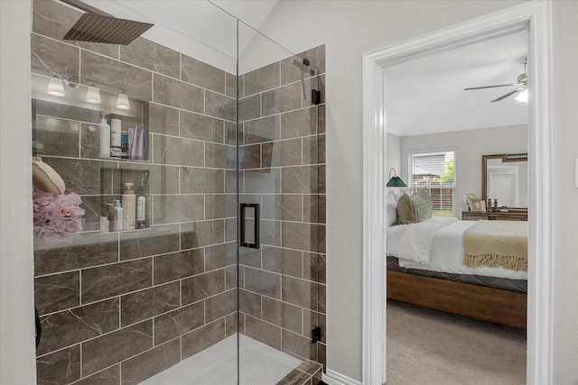 ensuite bathroom with ceiling fan, vaulted ceiling, a shower stall, and ensuite bath