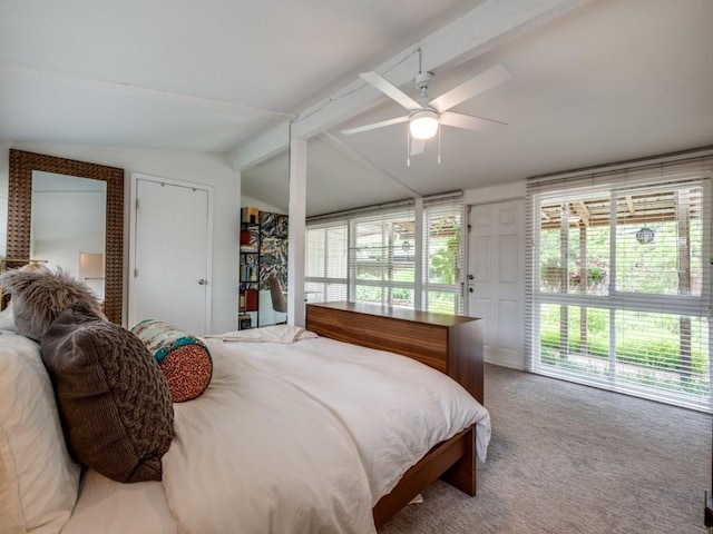 bedroom featuring a ceiling fan, lofted ceiling with beams, and carpet
