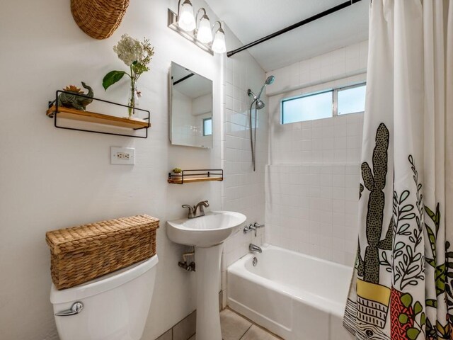 full bathroom with shower / bath combo and toilet