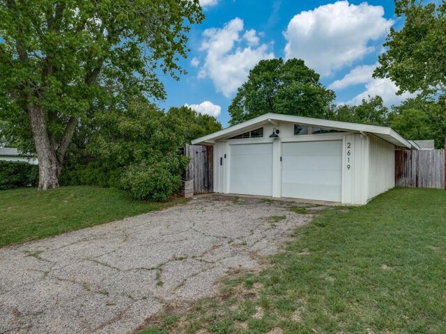 detached garage featuring fence