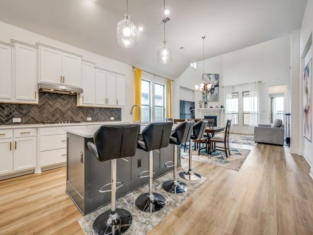 2513 Silver Leaf Dr, Northlake, TX 76226 - kitchen featuring under cabinet range hood, backsplash, open floor plan, and stovetop