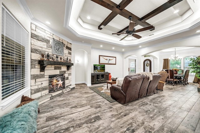 7839 Blanchard Way, Fort Worth, TX 76126 - living room featuring arched walkways, ornamental molding, a stone fireplace, and wood finished floors