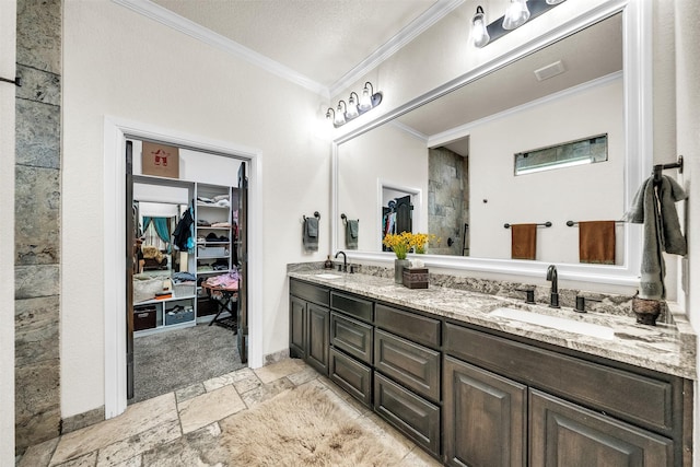 7839 Blanchard Way, Fort Worth, TX 76126 - bathroom with double vanity, a sink, stone tile flooring, a spacious closet, and ornamental molding