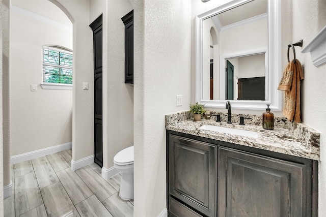 7839 Blanchard Way, Fort Worth, TX 76126 - bathroom featuring wood finish floors, vanity, toilet, baseboards, and ornamental molding