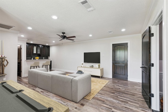 7839 Blanchard Way, Fort Worth, TX 76126 - living area featuring ornamental molding, recessed lighting, a textured ceiling, and visible vents