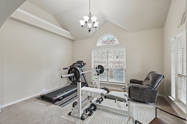 exercise area featuring carpet floors, baseboards, an inviting chandelier, and lofted ceiling