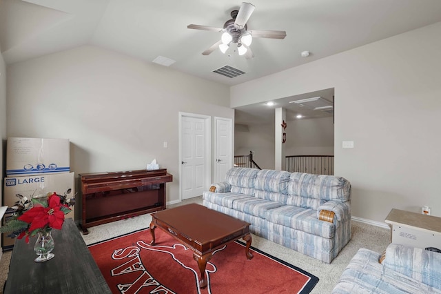 living area featuring visible vents, carpet floors, baseboards, a ceiling fan, and vaulted ceiling
