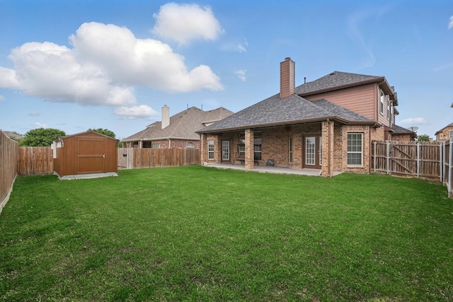 back of property with a patio, a fenced backyard, and a storage unit