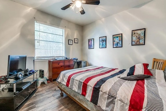 bedroom with a ceiling fan and wood finished floors