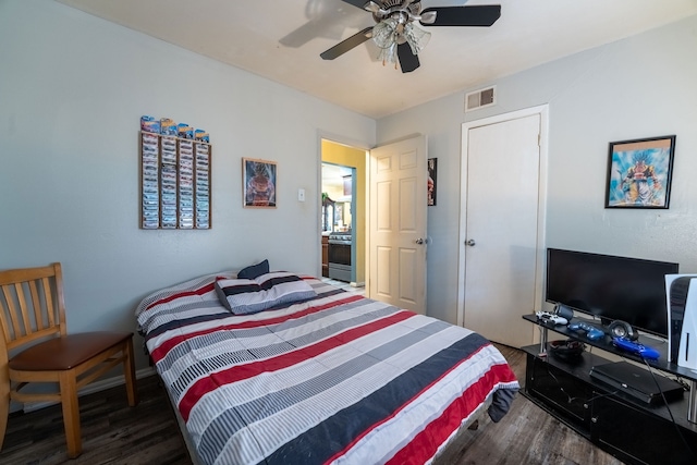 bedroom with a ceiling fan, wood finished floors, and visible vents