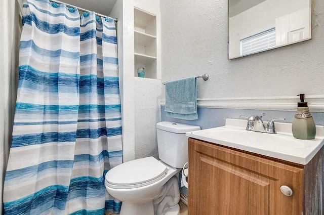 full bathroom featuring vanity, a textured wall, curtained shower, and toilet